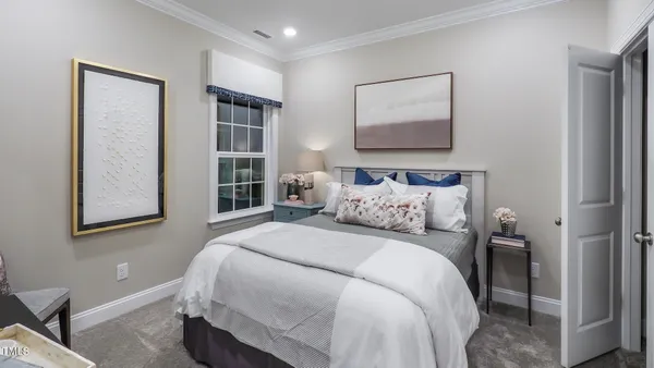 a bedroom with a large bed and a window