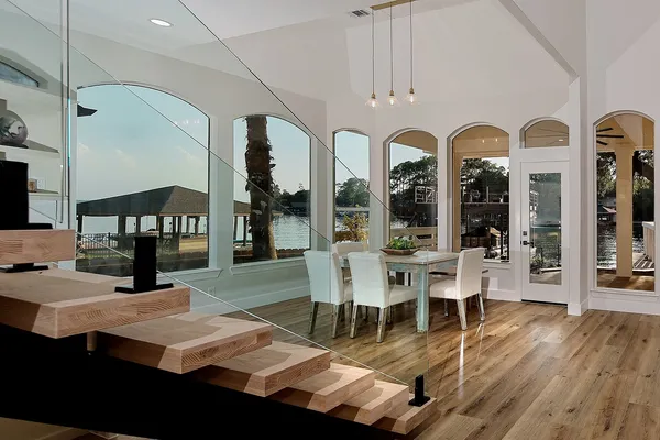 a bedroom with a bed and large windows