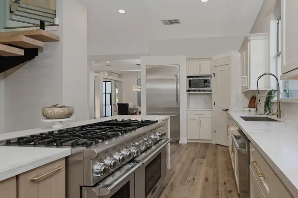 a bathroom with a sink a mirror a toilet and a bathtub