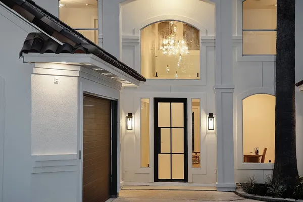 a bedroom with a bed and chandelier