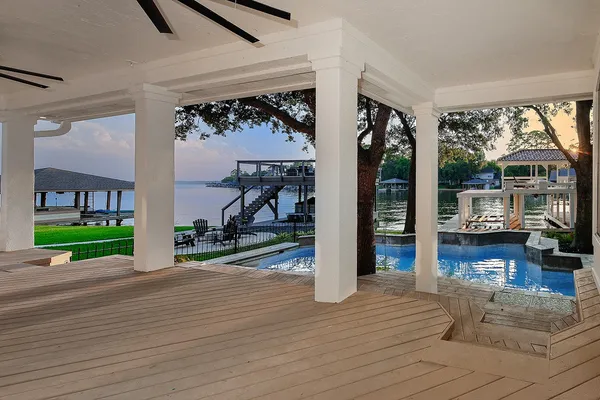 a view of a porch with wooden floor and a garden