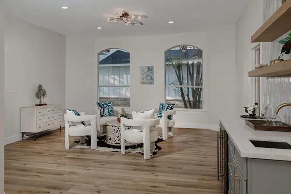 a view of a livingroom with furniture window and wooden floor