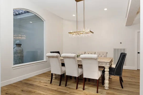a kitchen that has a sink a stove and wooden floor