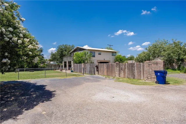a view of a house with a yard and a car park fire pit