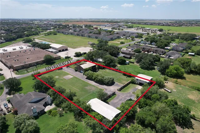 an aerial view of residential house with outdoor space and swimming pool