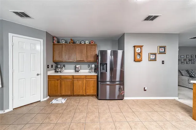 a kitchen with granite countertop a refrigerator and a sink