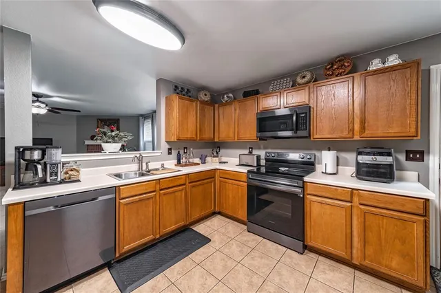 a kitchen with stainless steel appliances granite countertop a stove sink microwave and cabinets