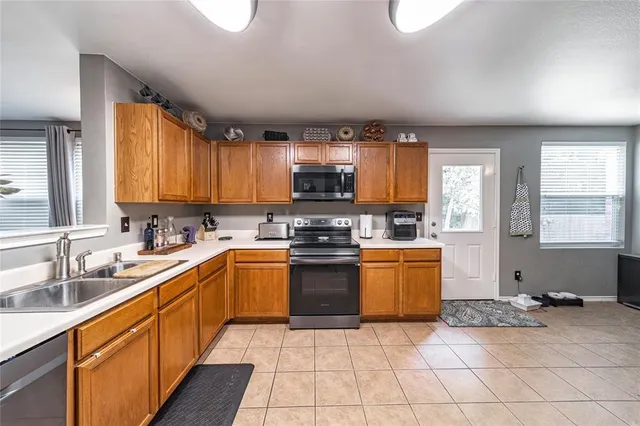 a kitchen with a stove a sink and a microwave