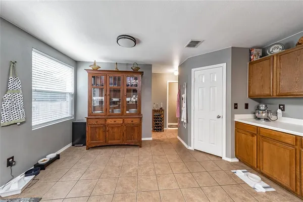 a room with a open kitchen view and chair