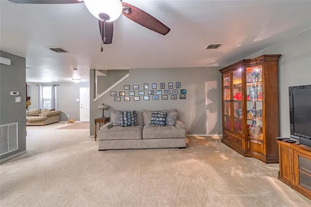 a spacious bedroom with a bed and a flat screen tv