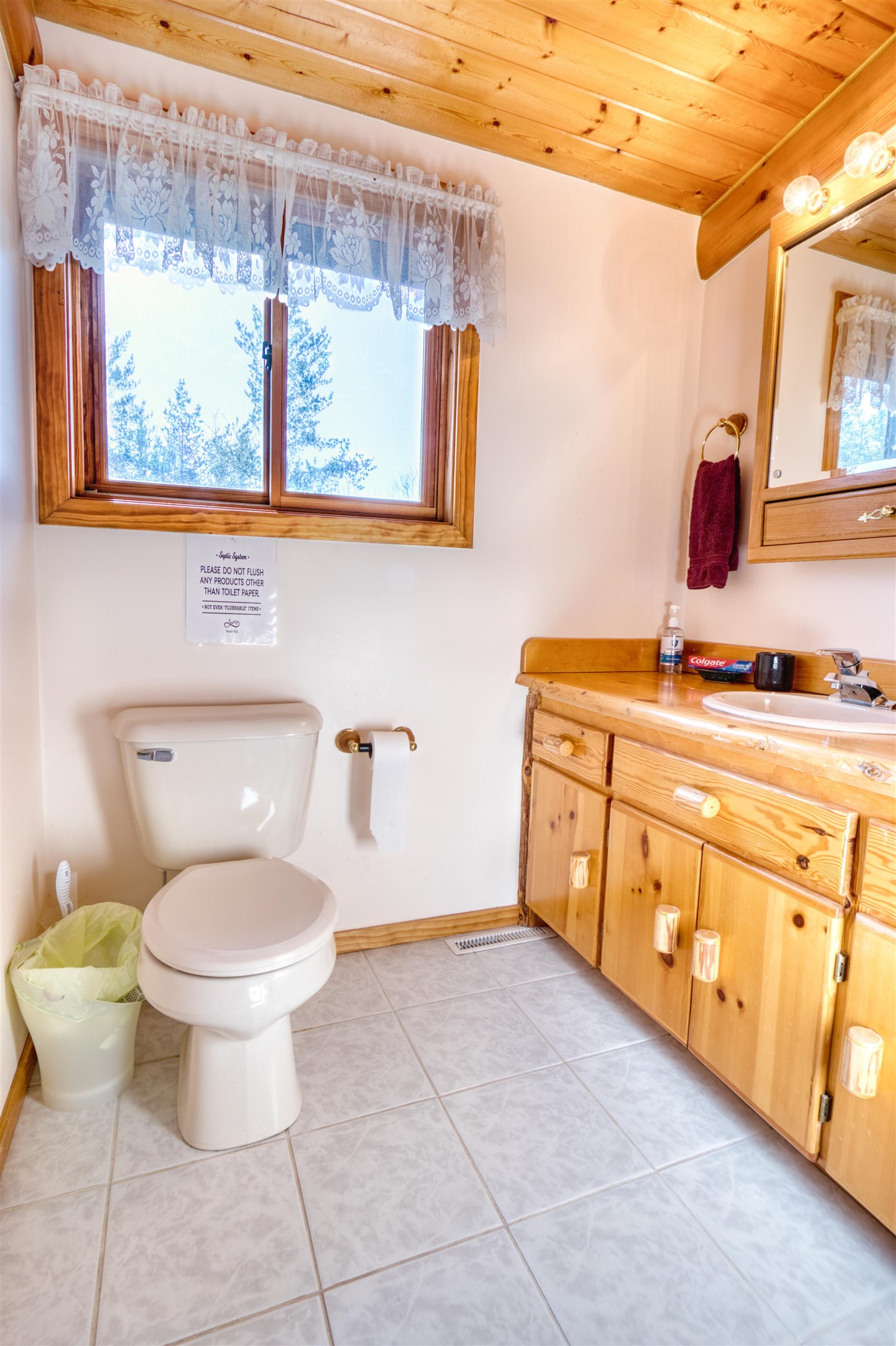 14366 North One Mile Road Minong, WI 54859 - Photo 30 of 40 Bathroom featuring tile patterned flooring, wood ceiling, toilet, vanity, and baseboards