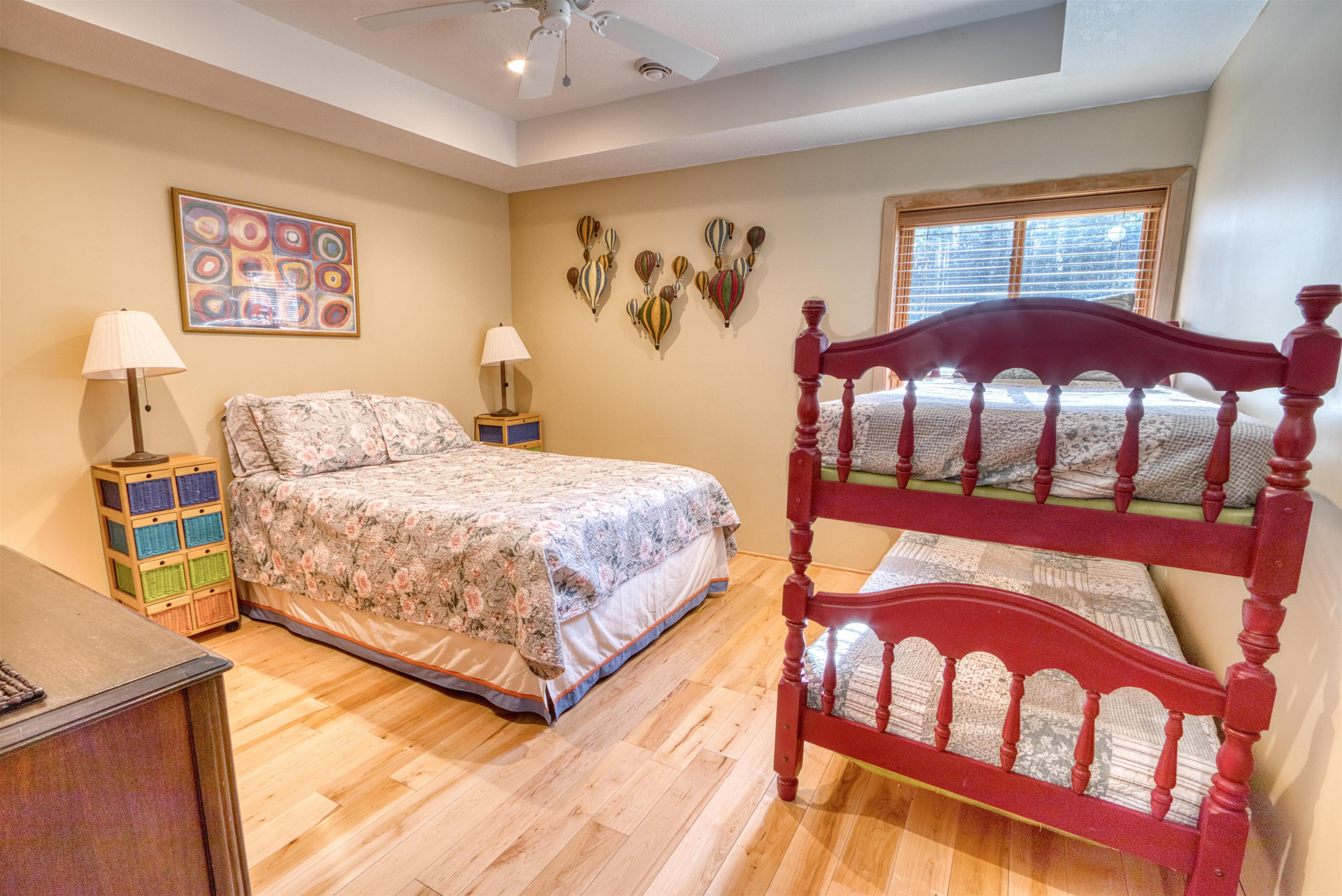 14366 North One Mile Road Minong, WI 54859 - Photo 38 of 40 Bedroom featuring a raised ceiling, light wood-style floors, ceiling fan, and recessed lighting