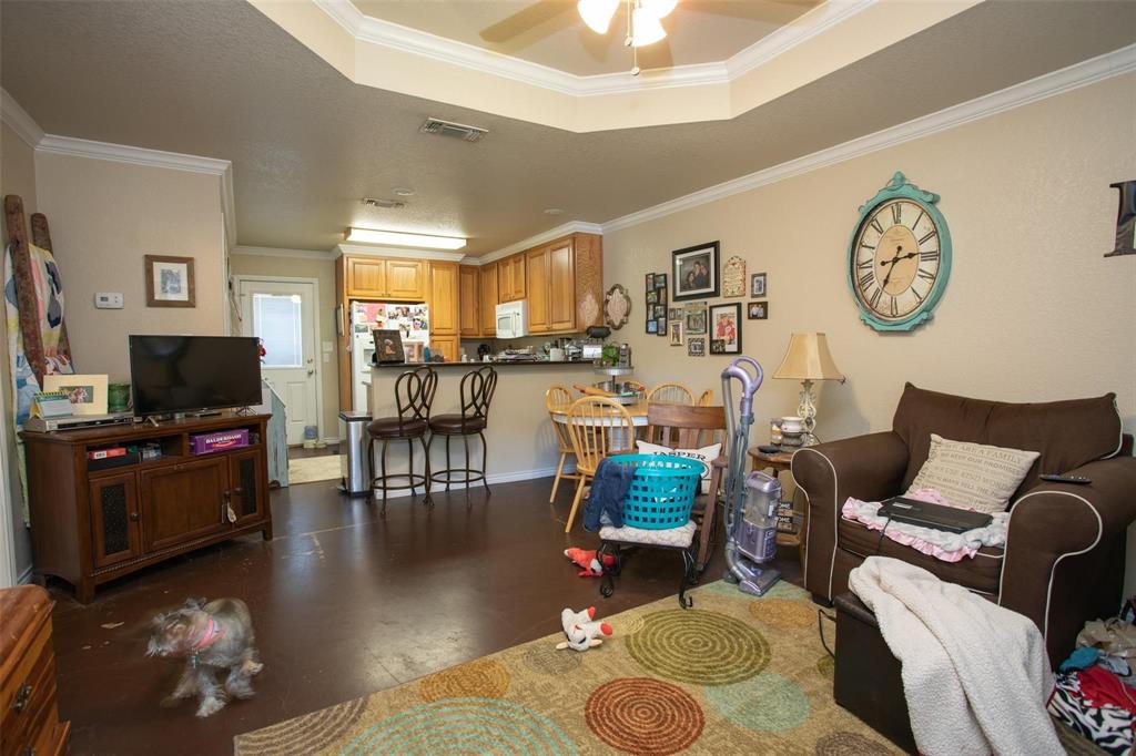 716 Rocky Ridge Flatts Oak Ridge, TX 76240 - Photo 5 of 10 Living area featuring ornamental molding, a ceiling fan, and finished concrete floors