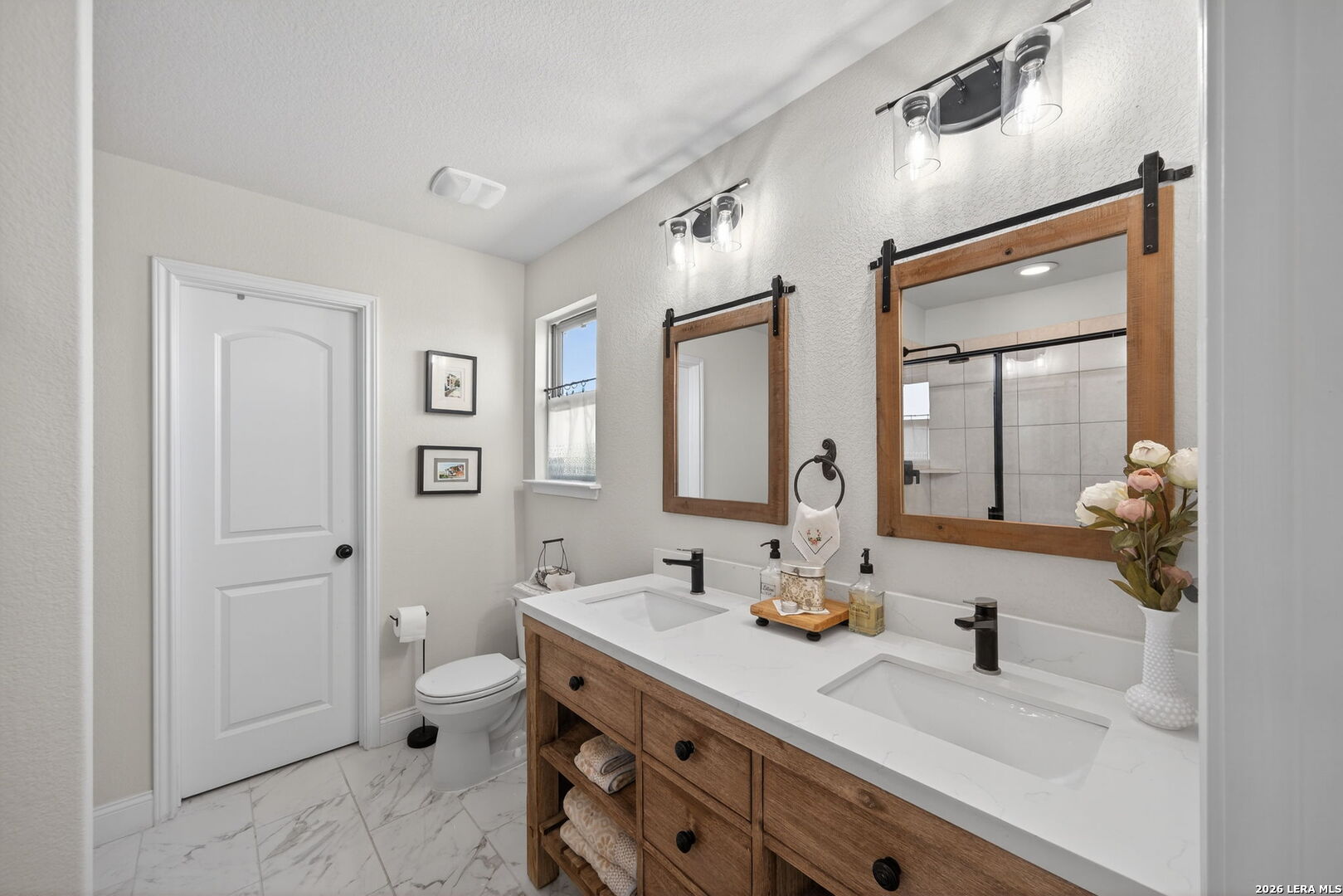 613 Whitman Avenue Georgetown, TX 78626 - Photo 17 of 24 a bathroom with a double vanity sink mirror and toilet