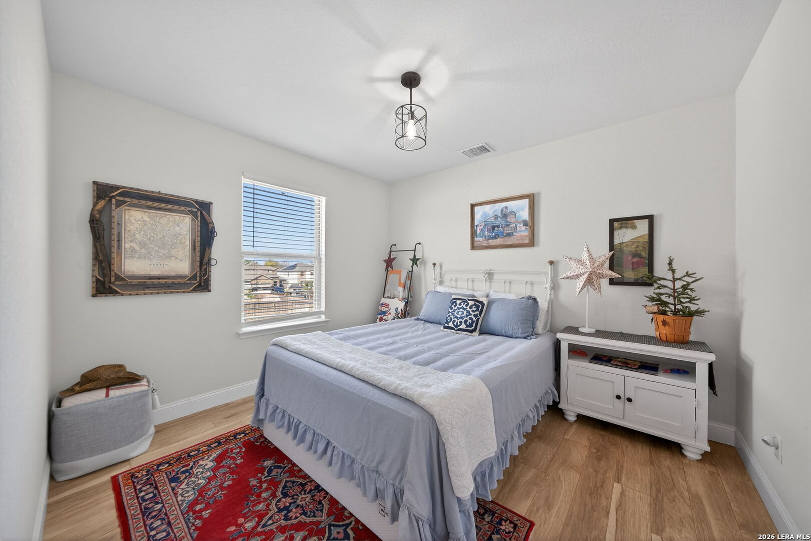 613 Whitman Avenue Georgetown, TX 78626 - Photo 20 of 24 a bedroom with a bed and a chandelier