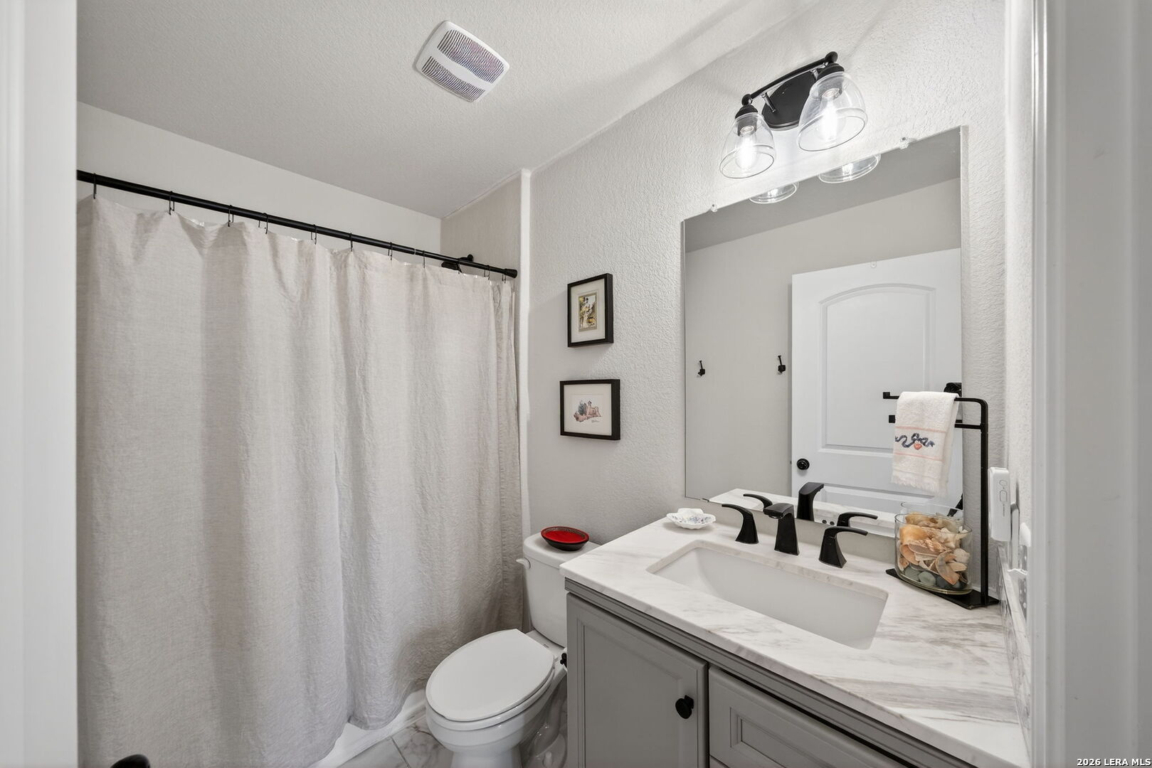 613 Whitman Avenue Georgetown, TX 78626 - Photo 21 of 24 a bathroom with a granite countertop sink vanity mirror and toilet