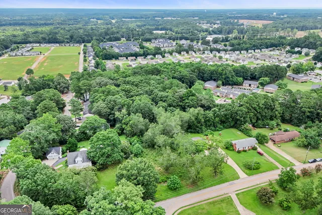 an aerial view of residential houses and outdoor space