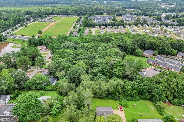 an aerial view of a house with yard