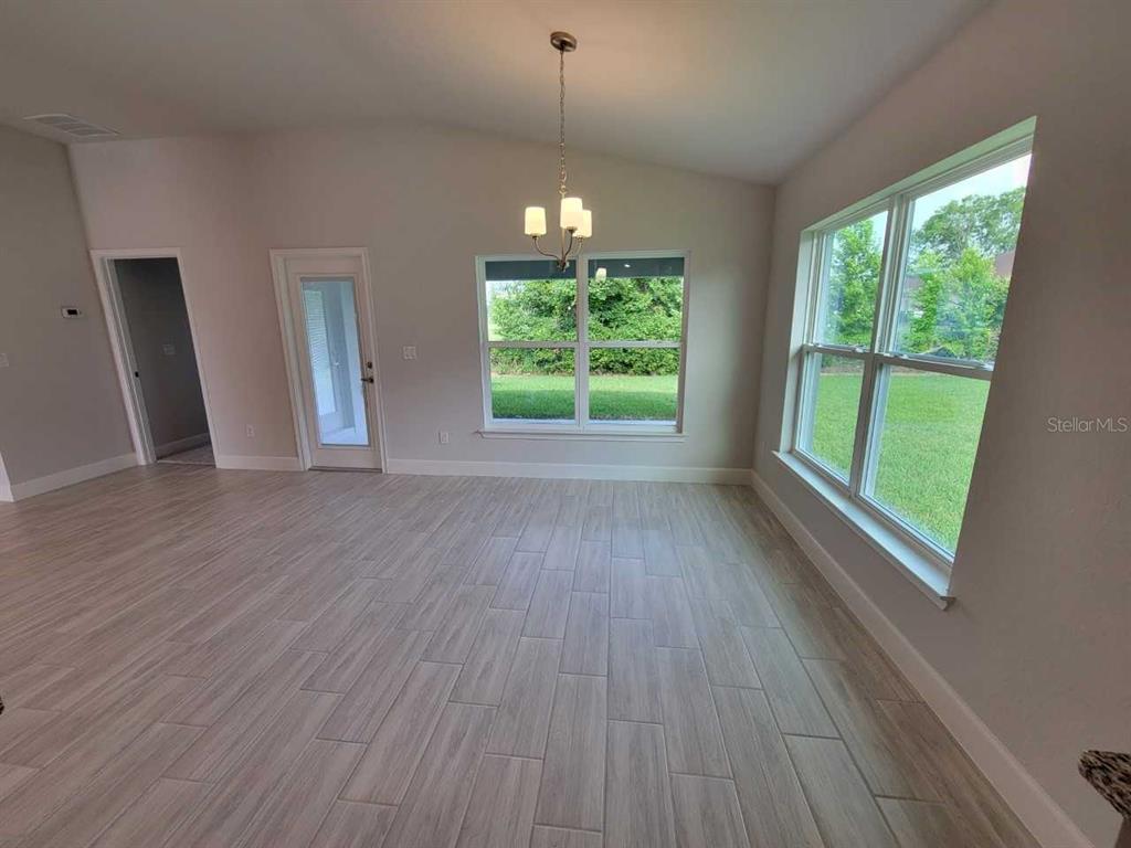 4525 Southwest 91st Ln Road Ocala, FL 34476 - Photo 11 of 20 a view of an empty room with wooden floor and a window