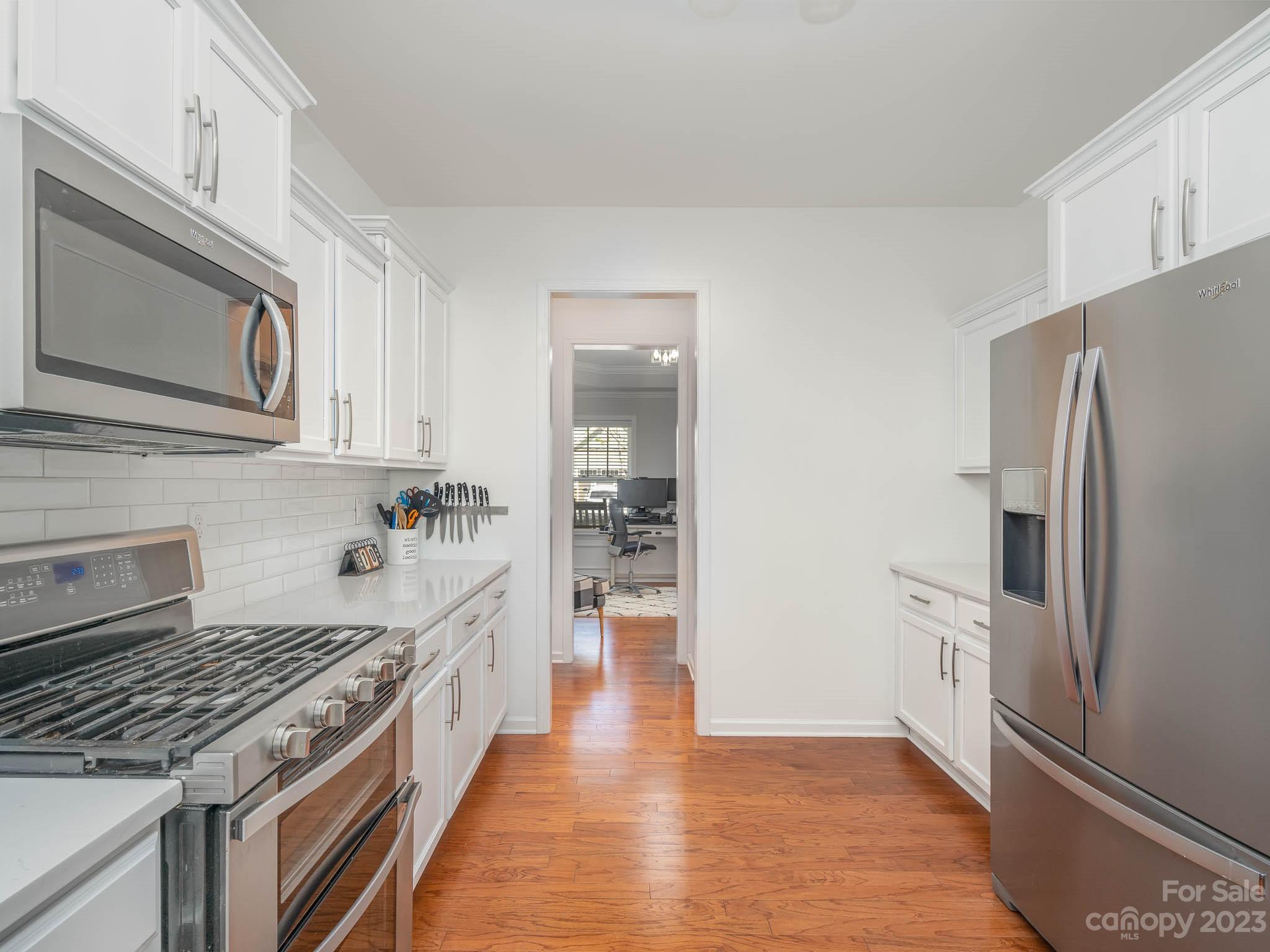 2185 Bluebell Way Tega Cay, SC 29708 - Photo 11 of 45 a kitchen with stainless steel appliances a refrigerator a stove top oven and cabinets