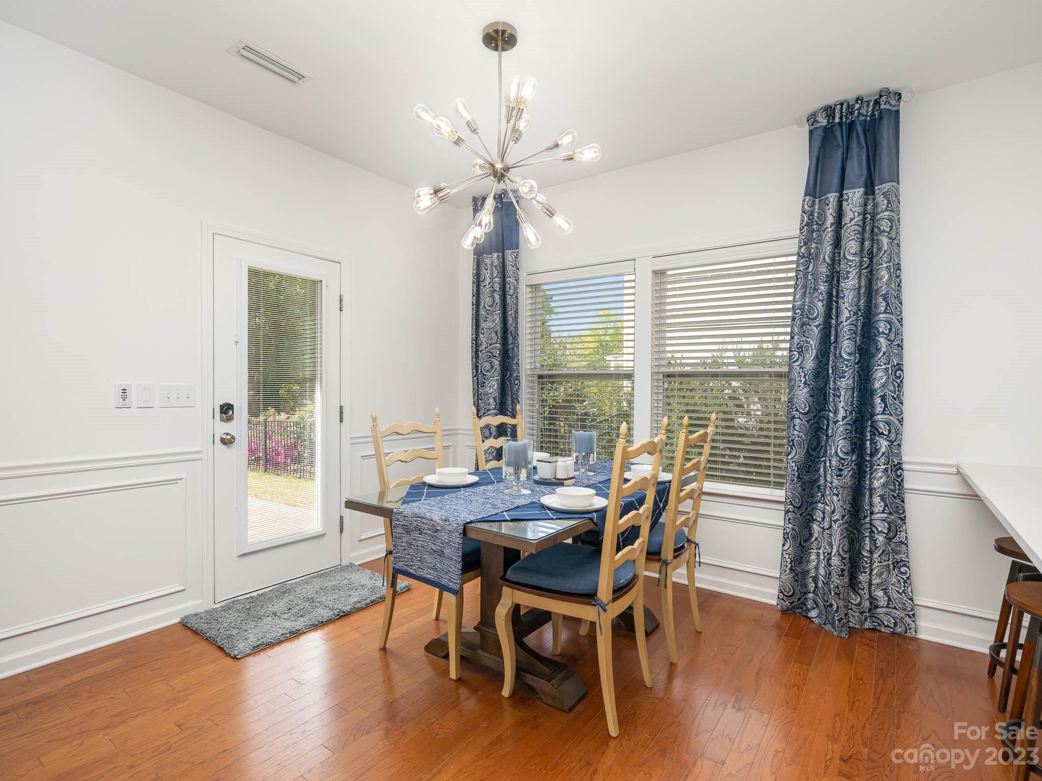 2185 Bluebell Way Tega Cay, SC 29708 - Photo 14 of 45 a view of a dining room with furniture window and wooden floor