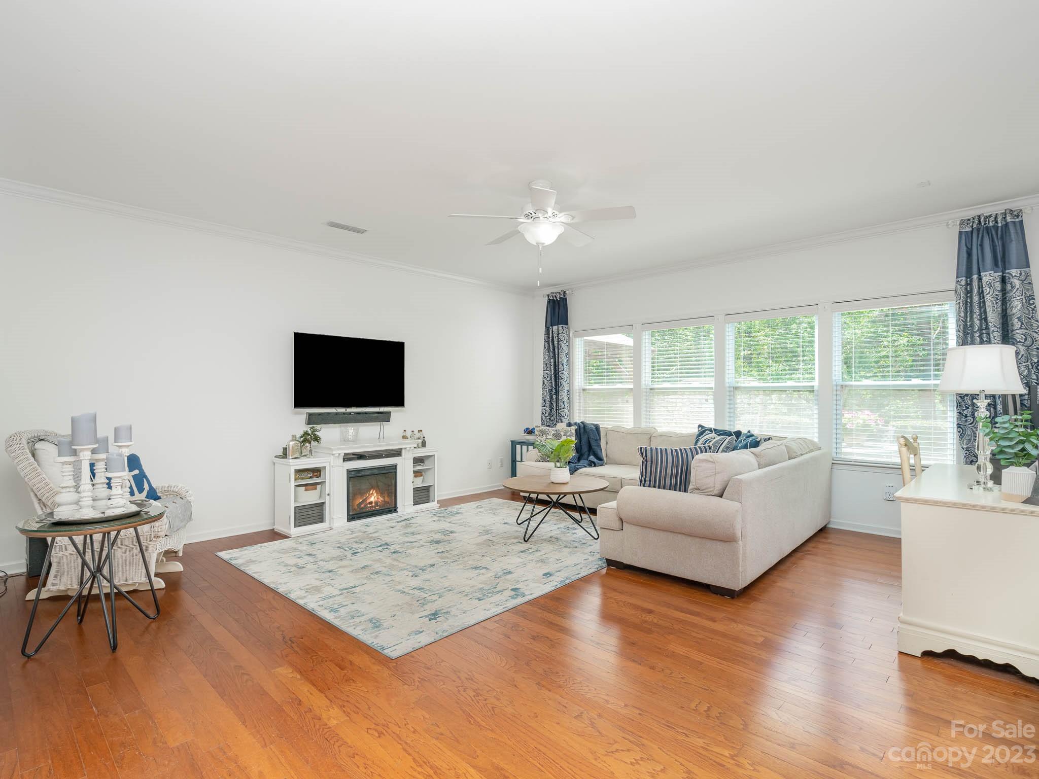 2185 Bluebell Way Tega Cay, SC 29708 - Photo 15 of 45 a living room with furniture a flat screen tv and a large window