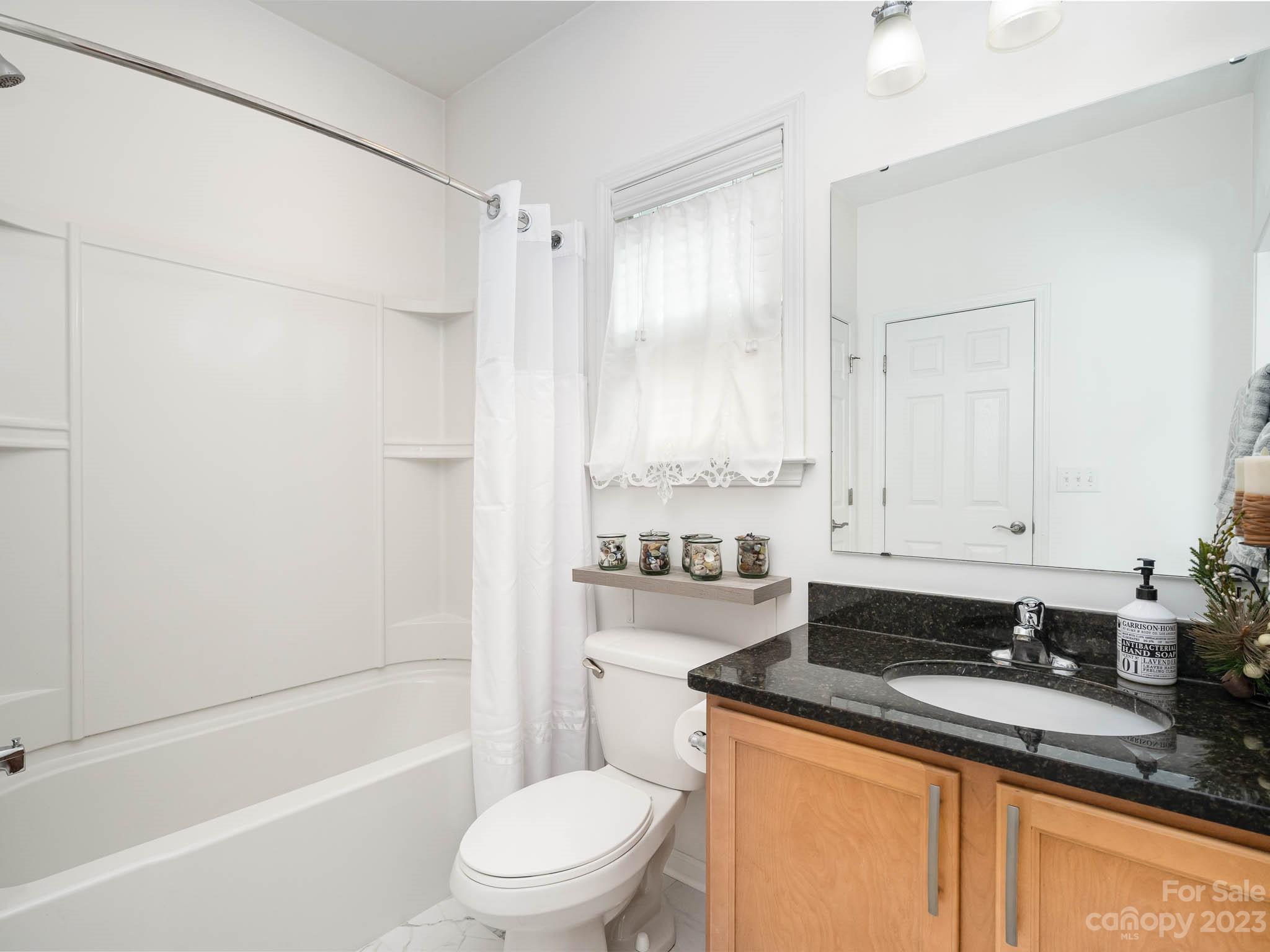 2185 Bluebell Way Tega Cay, SC 29708 - Photo 21 of 45 a bathroom with a granite countertop sink a toilet and shower
