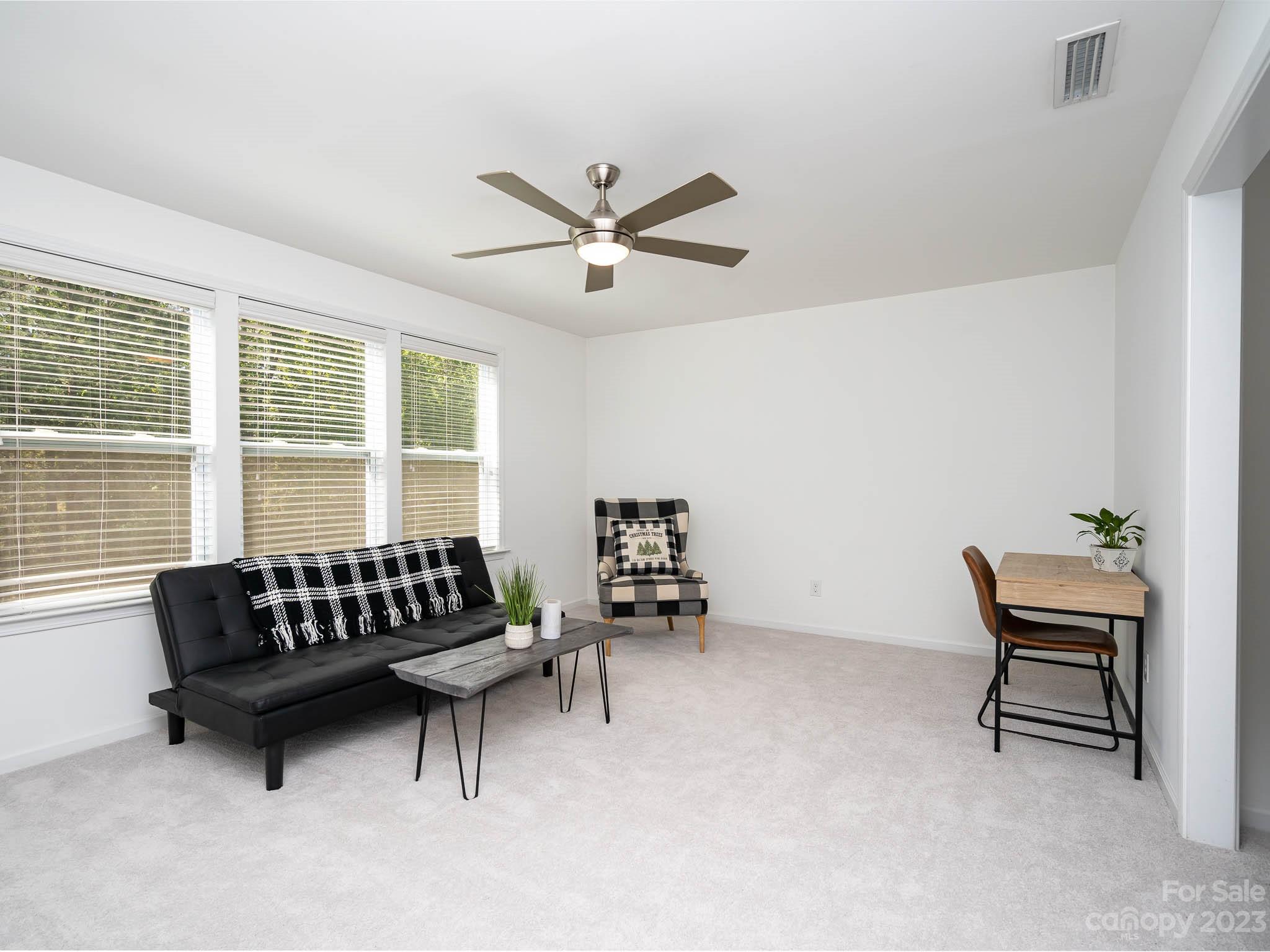 2185 Bluebell Way Tega Cay, SC 29708 - Photo 28 of 45 a living room with furniture and a window