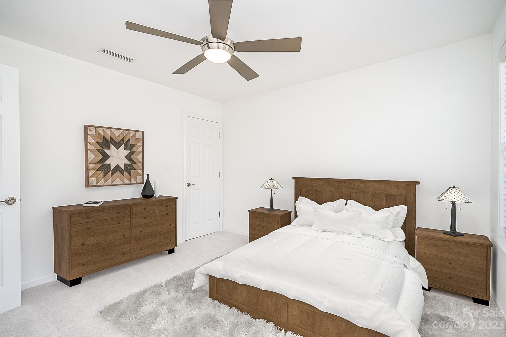 2185 Bluebell Way Tega Cay, SC 29708 - Photo 31 of 45 a bedroom with a bed and a chandelier