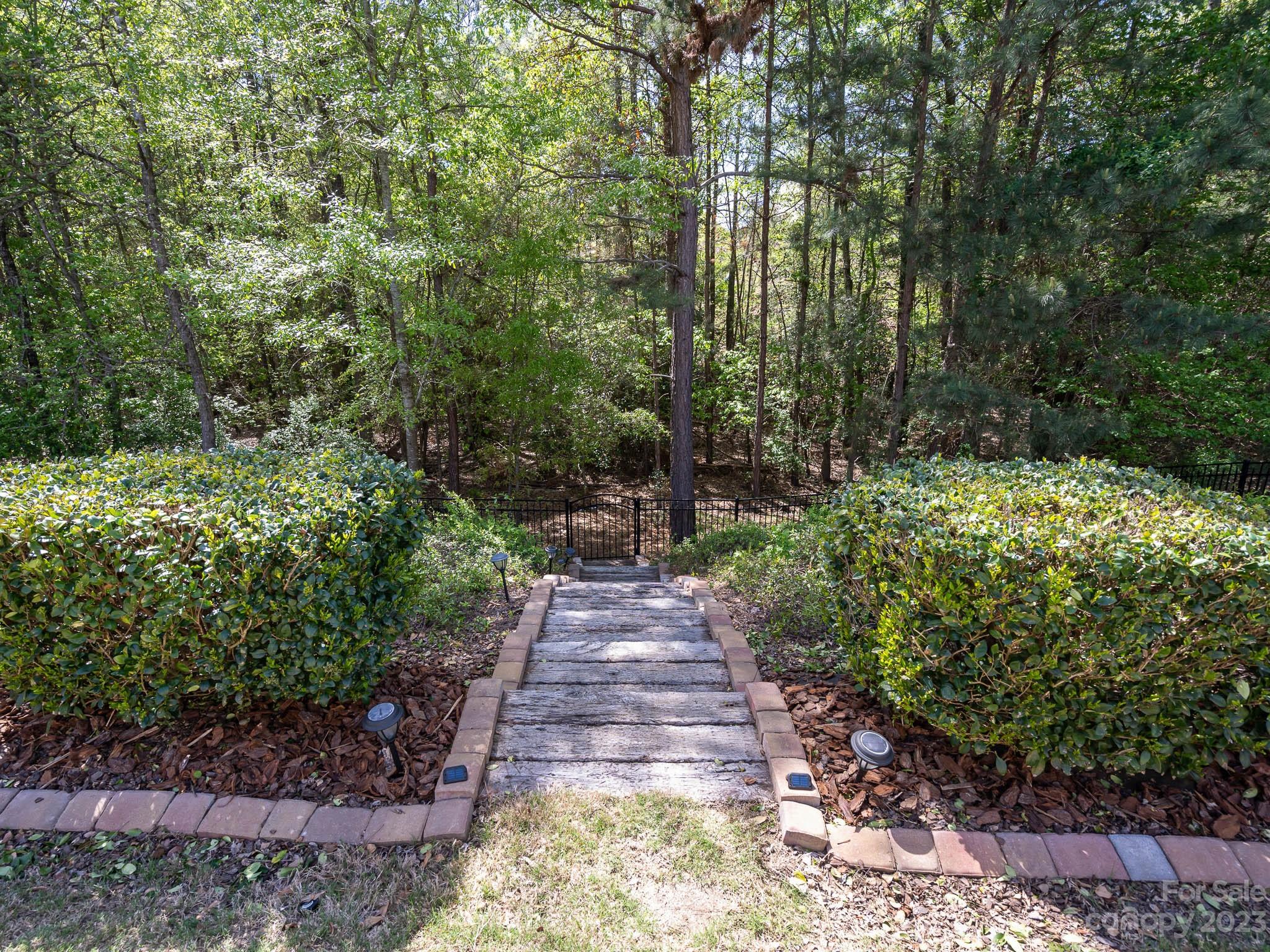 2185 Bluebell Way Tega Cay, SC 29708 - Photo 36 of 45 a view of a pathway both side of yard