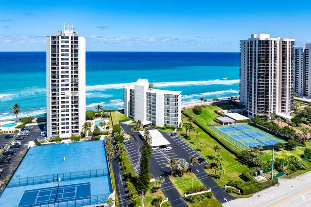 an aerial view of a residential apartment building with a yard