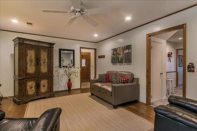 a living room with furniture floor to ceiling window and flat screen tv