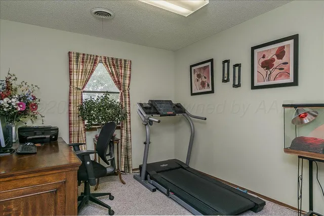 a view of a dining room with furniture a chandelier and window