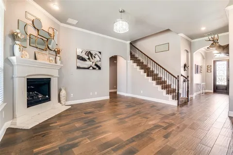 a view of a livingroom with wooden floor and a fireplace