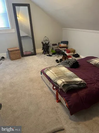 a bed sitting in a room next to a window