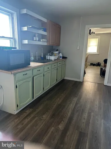 a kitchen with cabinets a sink and appliances