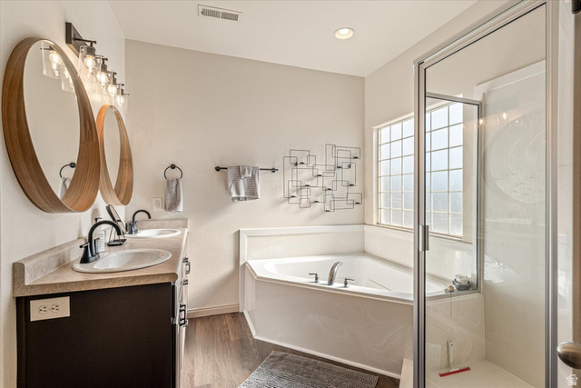 345 North 2450th Street East, Unit 152 St. George, UT 84790 - Photo 19 of 40 Bathroom with a bath, double vanity, a stall shower, dark wood finished floors, and recessed lighting