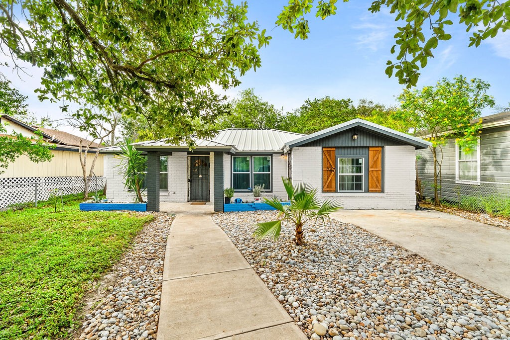 647 West Main Avenue Robstown, TX 78380 - Photo 1 of 16 a front view of a house with a garden