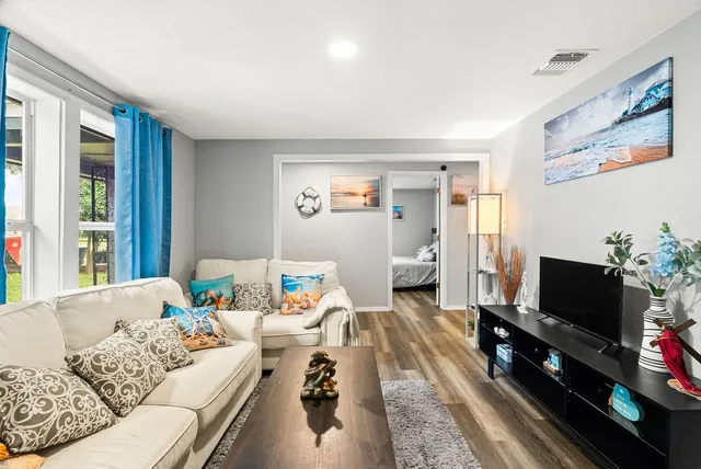 a living room with furniture and a flat screen tv