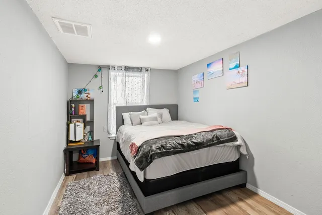 a bedroom with a bed and dresser