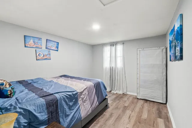 a bedroom with a bed and a window