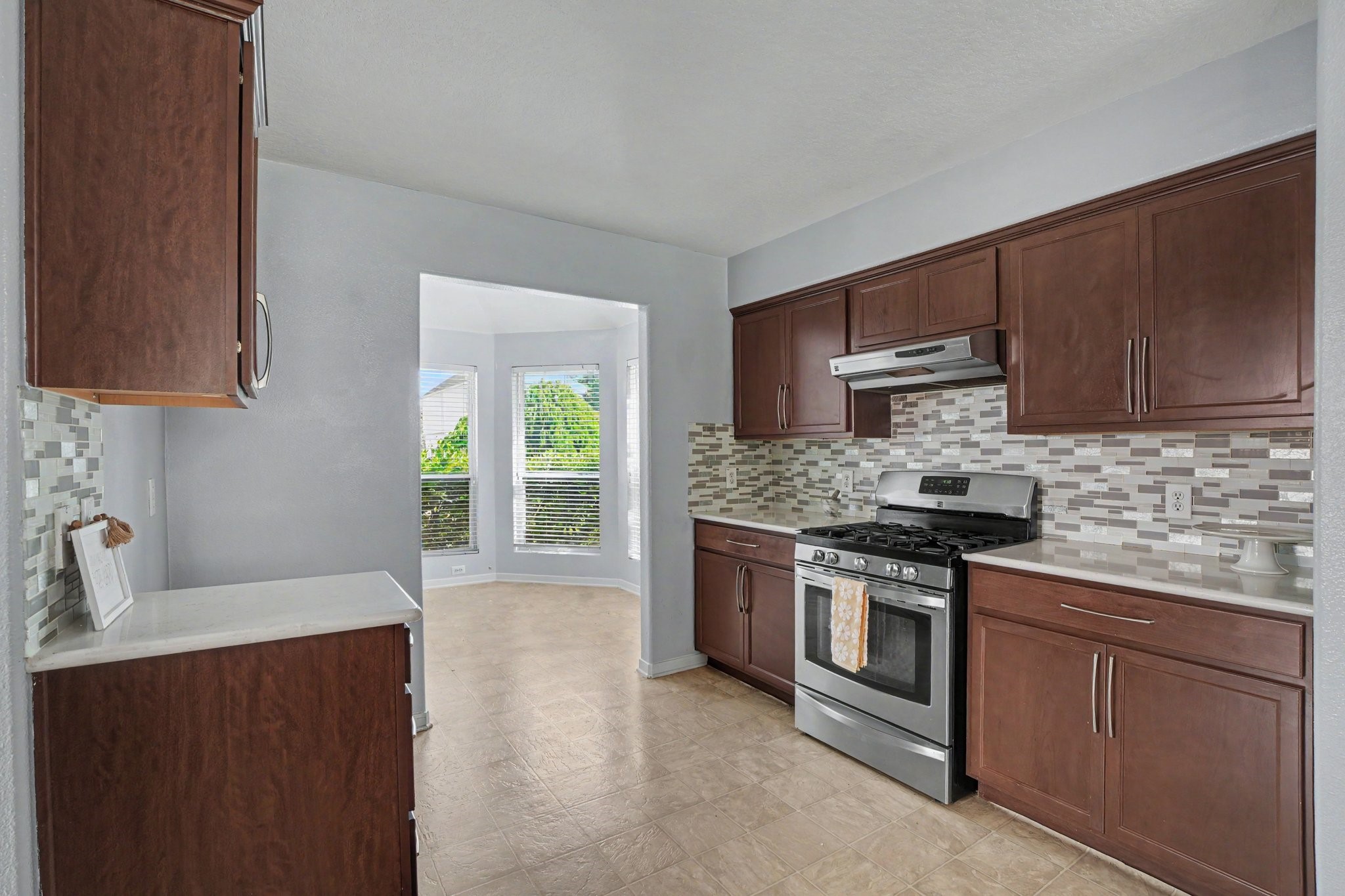 5622 Wasabi Lane Baytown, TX 77521 - Photo 8 of 29 a kitchen with stainless steel appliances granite countertop a stove a sink and a microwave