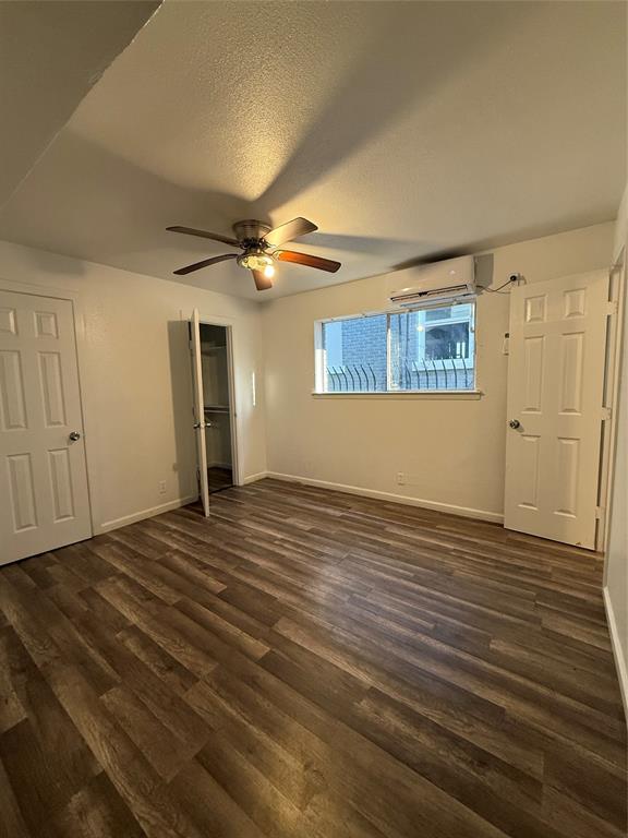 2701 Hemphill Street Fort Worth, TX 76110 - Photo 7 of 11 a view of a livingroom with a ceiling fan window and hardwood floor