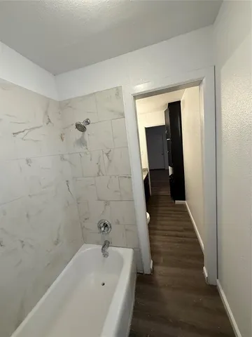 a bathroom with a bathtub and shower