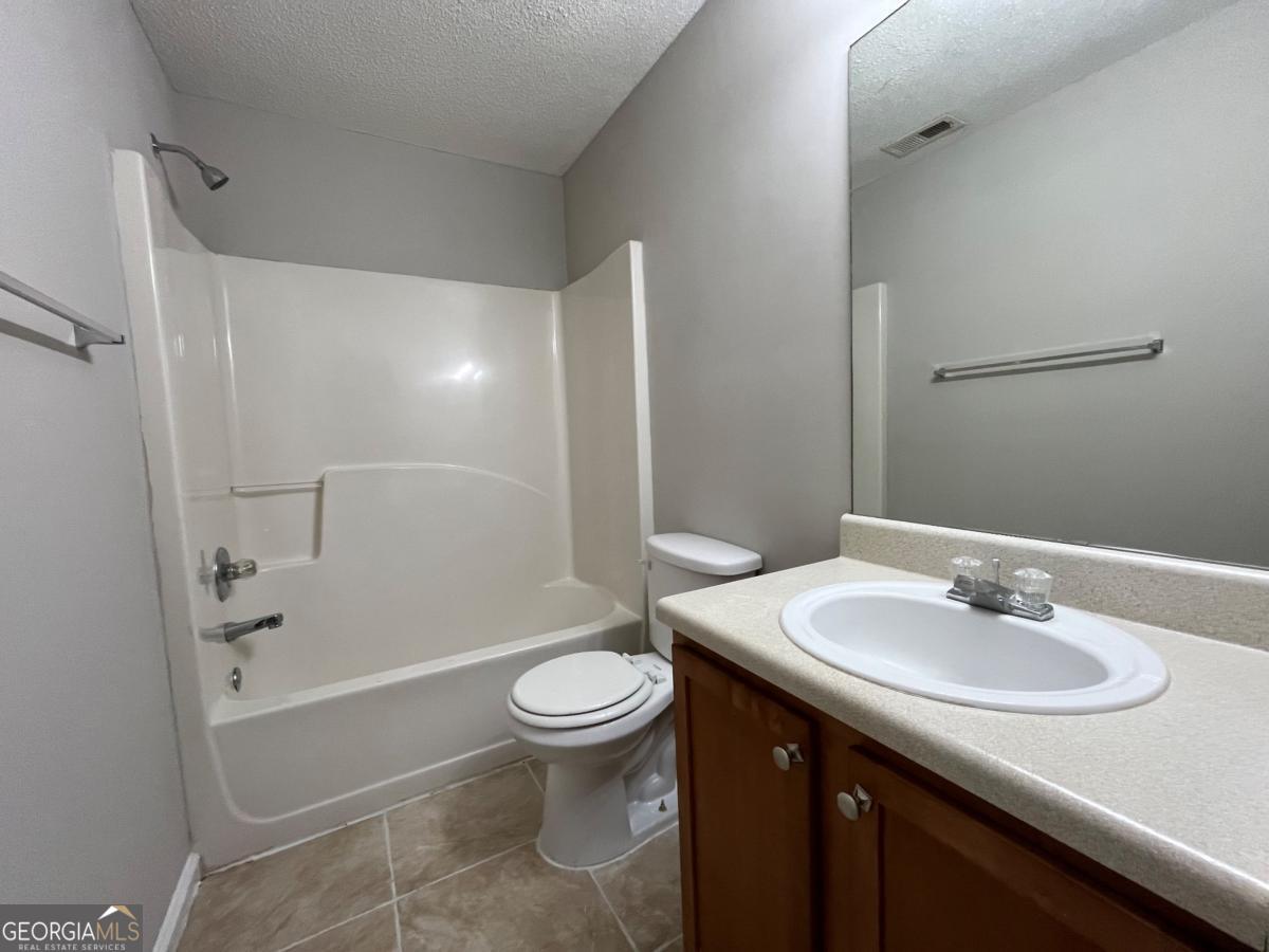 3604 Ginnis Road, Unit 1 Atlanta, GA 30331 - Photo 12 of 15 a bathroom with a sink toilet and shower