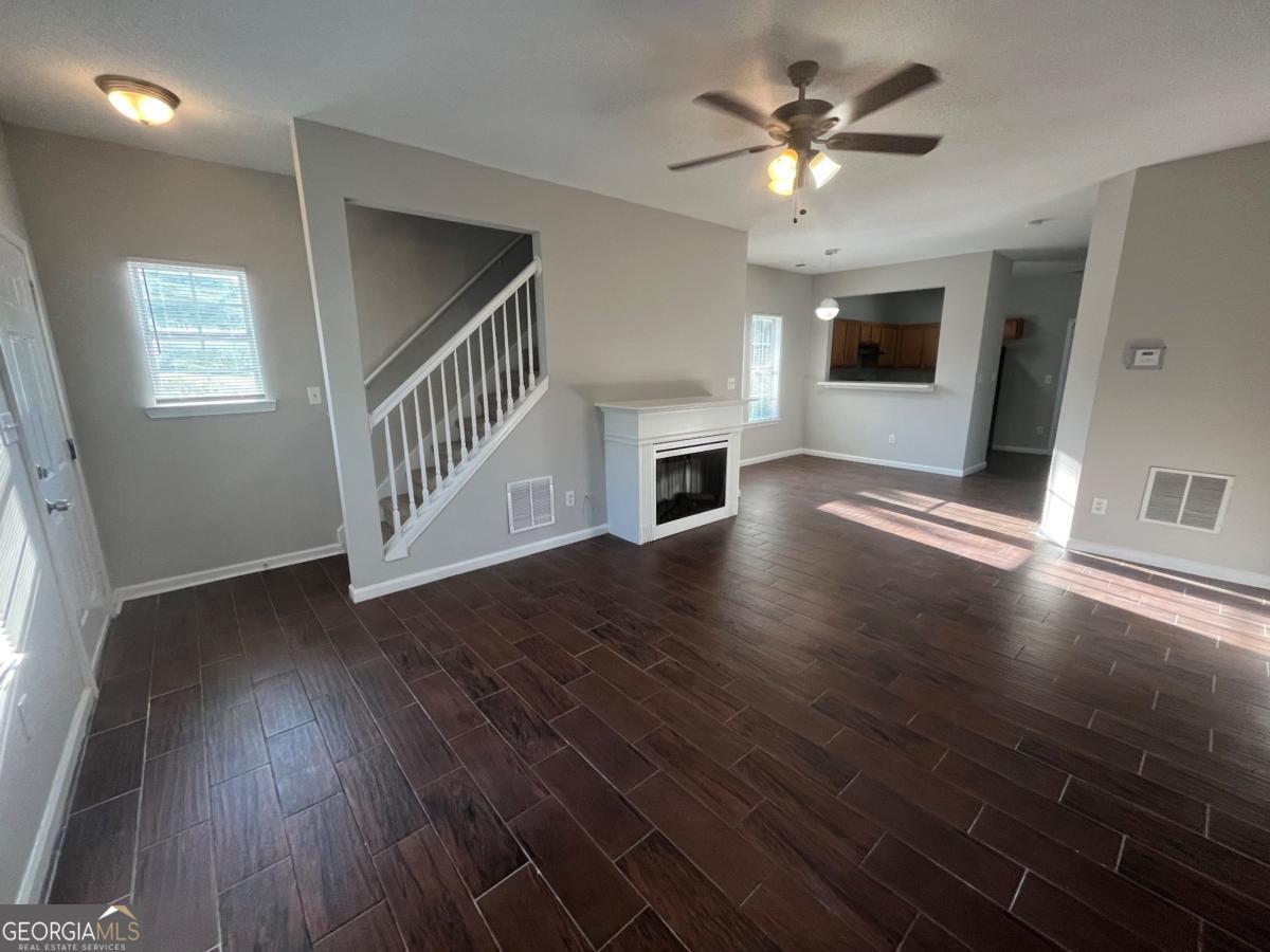3604 Ginnis Road, Unit 1 Atlanta, GA 30331 - Photo 2 of 15 a view of an empty room with wooden floor and a ceiling fan