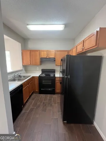 a kitchen with stainless steel appliances a refrigerator and a stove