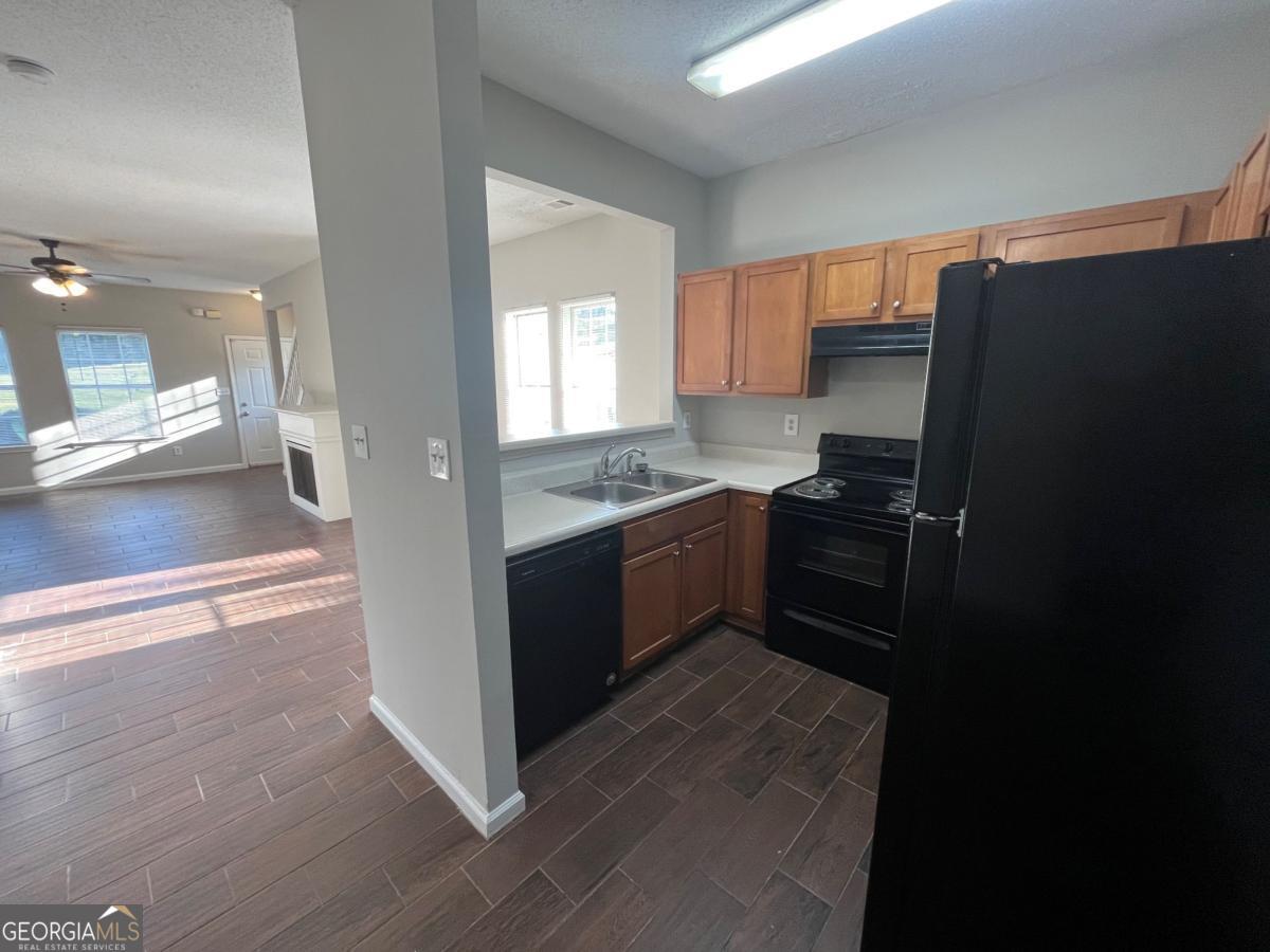 3604 Ginnis Road, Unit 1 Atlanta, GA 30331 - Photo 7 of 15 a kitchen with a refrigerator and a sink