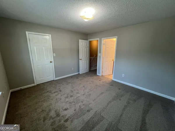 a view of an empty room and a window