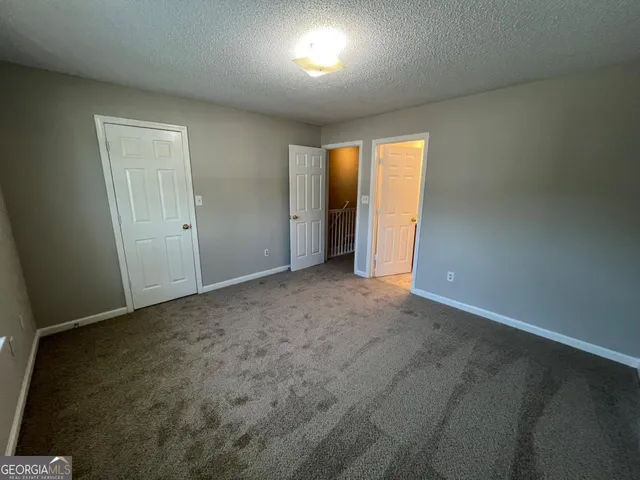 a view of an empty room and a window